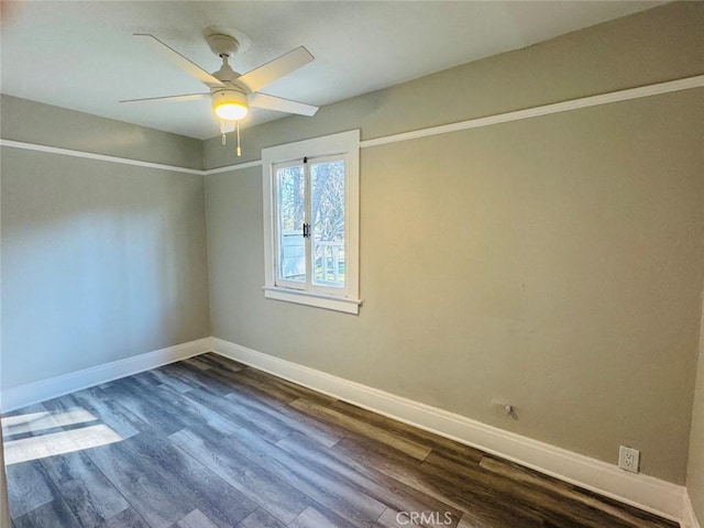 empty room featuring baseboards, ceiling fan, and dark wood-style flooring