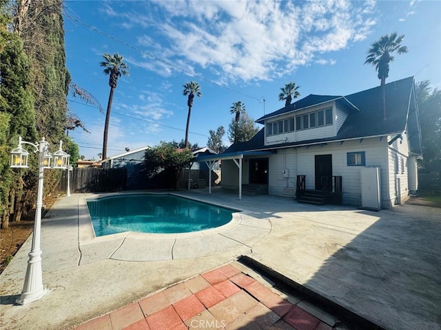 view of pool featuring a fenced in pool, fence, entry steps, and a patio area