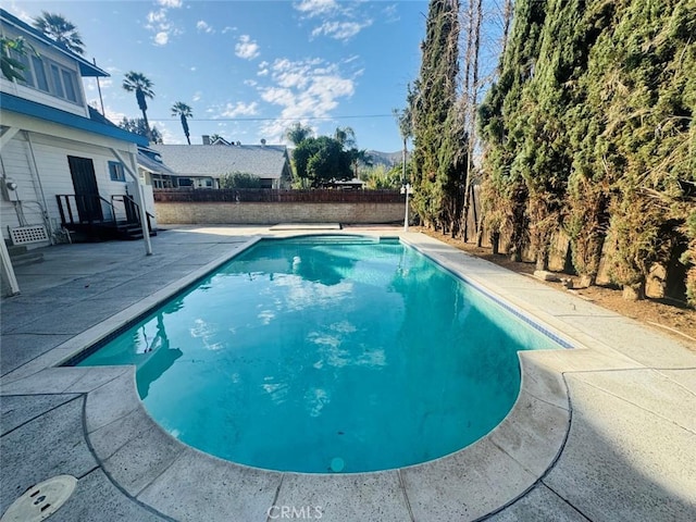 view of swimming pool with a fenced in pool and a patio