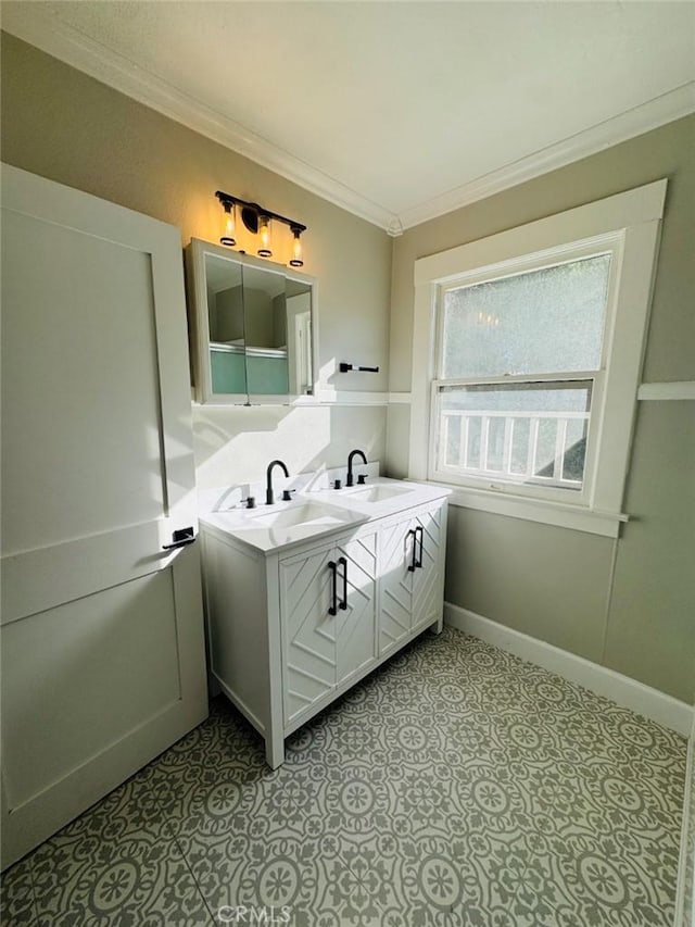 full bathroom featuring a sink, baseboards, double vanity, and crown molding