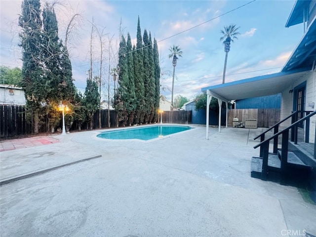 view of swimming pool featuring a patio area, a fenced backyard, and a fenced in pool