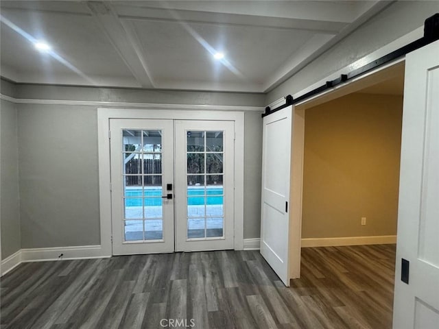 entryway featuring baseboards, dark wood-style flooring, french doors, a barn door, and beamed ceiling