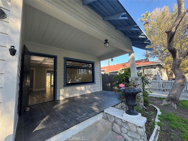 view of patio / terrace featuring a deck and fence