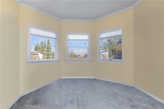 unfurnished room featuring crown molding, baseboards, and a wealth of natural light