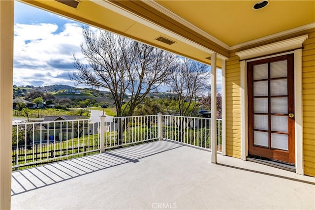 view of patio featuring a balcony and a mountain view