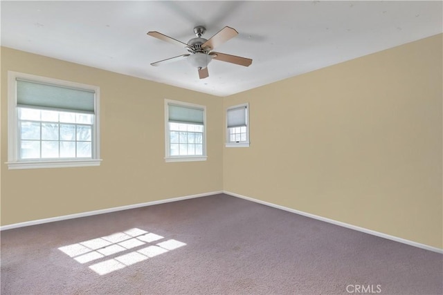 unfurnished room with carpet, baseboards, and ceiling fan