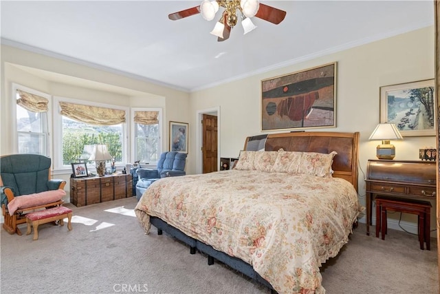 bedroom with ornamental molding, a ceiling fan, and carpet floors