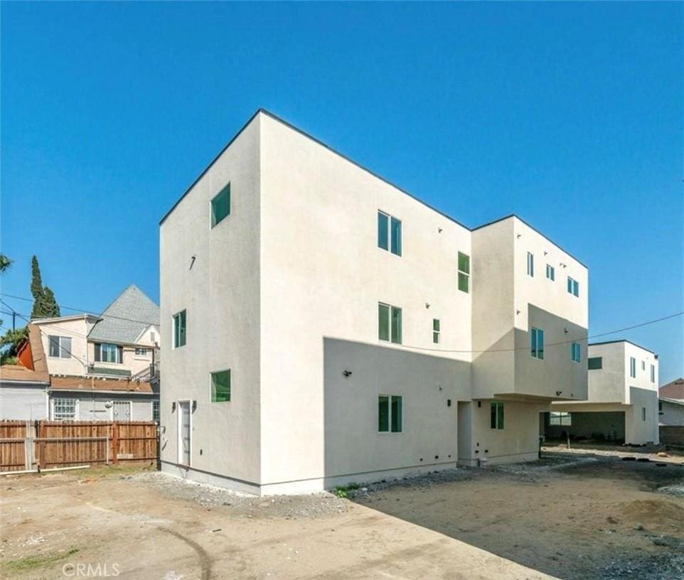 2415 E 3rd St, Los Angeles, CA 90033 - rear view of property featuring stucco siding and fence