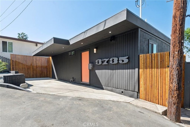 contemporary home with fence