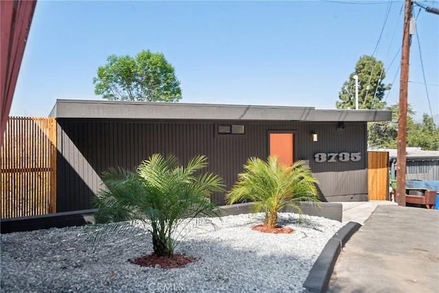 view of outbuilding with fence