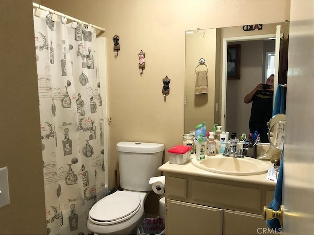 bathroom with a shower with shower curtain, toilet, and vanity