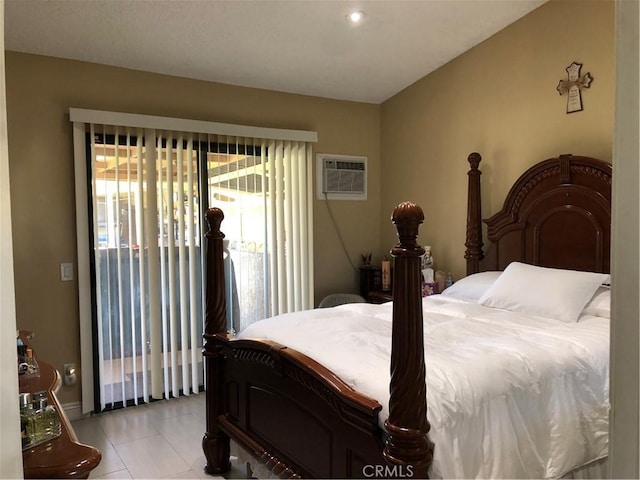 bedroom featuring light tile patterned floors, a wall mounted air conditioner, and access to outside