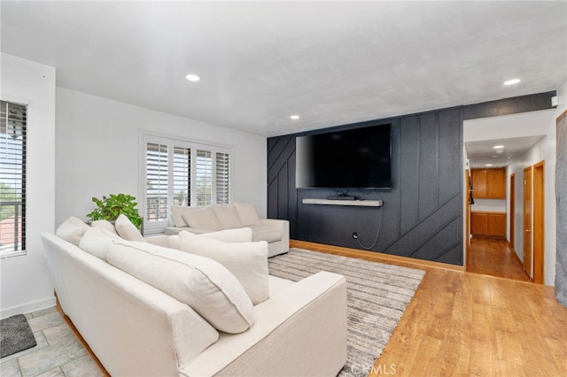 living area featuring recessed lighting, baseboards, plenty of natural light, and wood finished floors