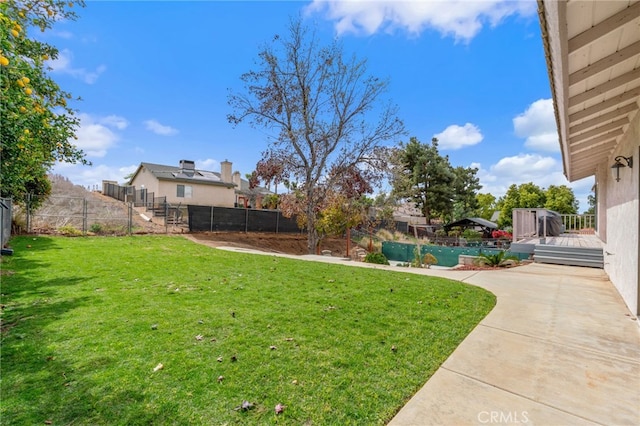 view of yard featuring a deck and a fenced backyard