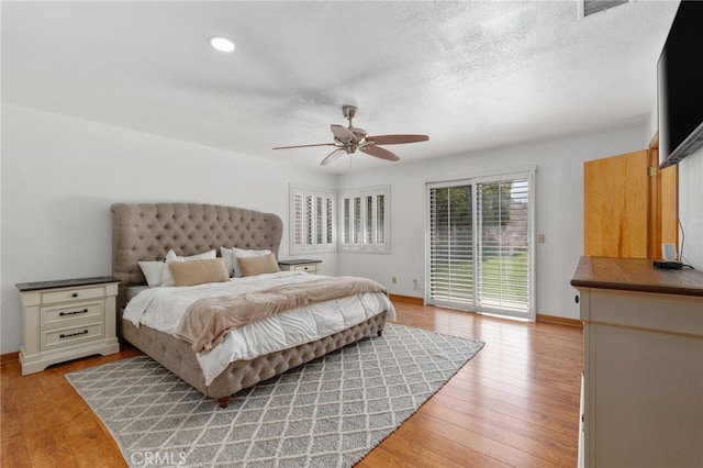 bedroom with access to exterior, baseboards, and light wood finished floors