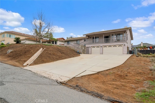 view of front of home with an attached garage, driveway, and stucco siding