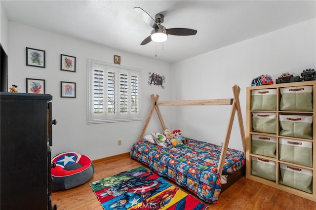 bedroom with wood finished floors and a ceiling fan