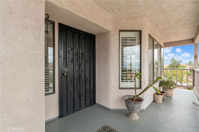 doorway to property featuring stucco siding