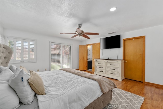 bedroom with a ceiling fan, a textured ceiling, recessed lighting, light wood finished floors, and baseboards