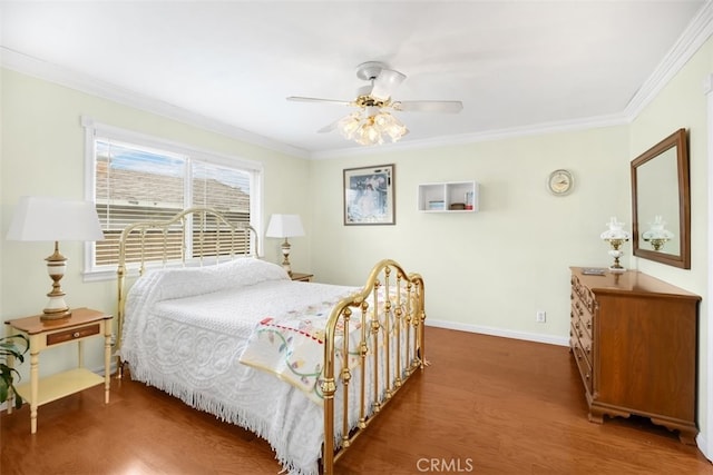 bedroom featuring ceiling fan, crown molding, baseboards, and wood finished floors