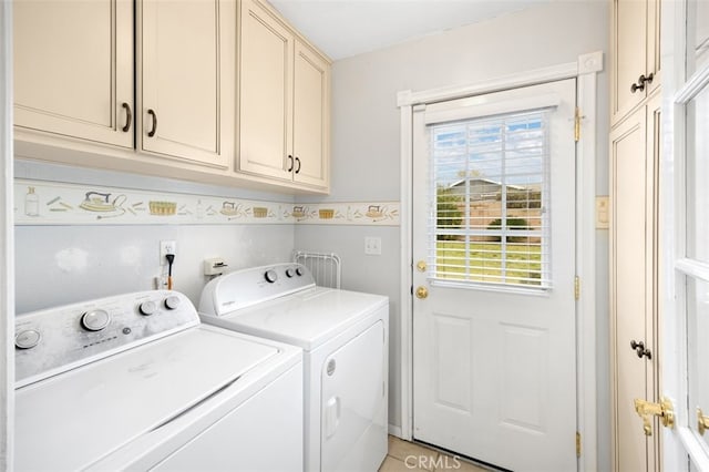 laundry area with cabinet space and independent washer and dryer