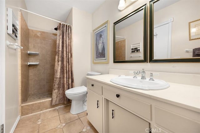 bathroom featuring a tile shower, tile patterned flooring, toilet, and vanity