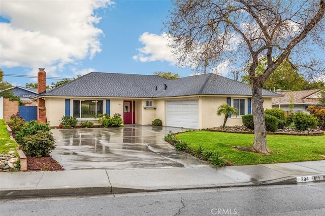 ranch-style house with a garage, stucco siding, driveway, and a front yard