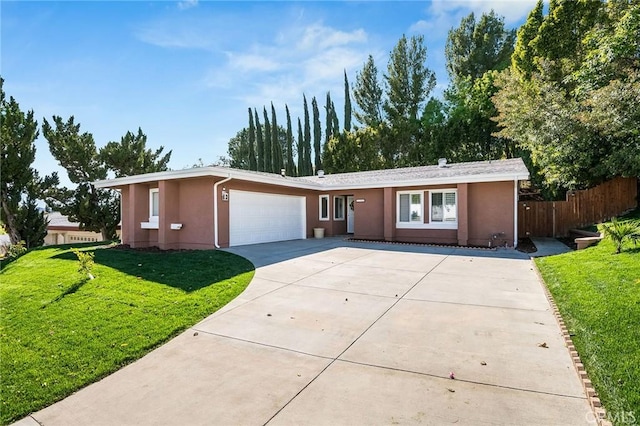 ranch-style house with a front lawn, fence, concrete driveway, stucco siding, and an attached garage