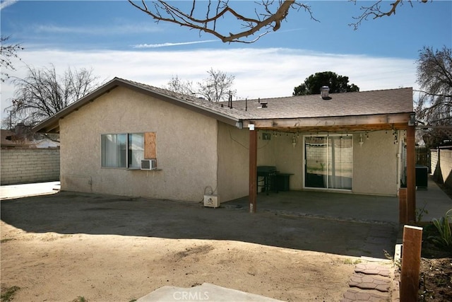 back of property featuring stucco siding, fence, cooling unit, and a patio area