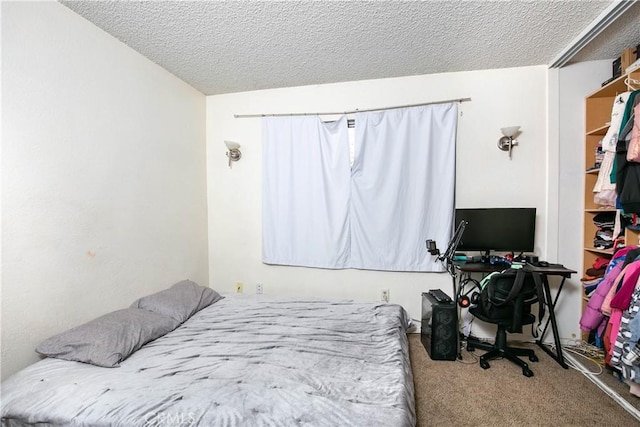 carpeted bedroom with a textured ceiling