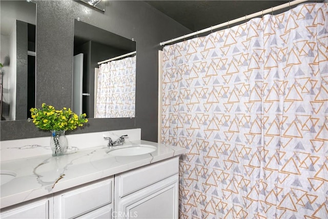 full bath featuring a sink and double vanity