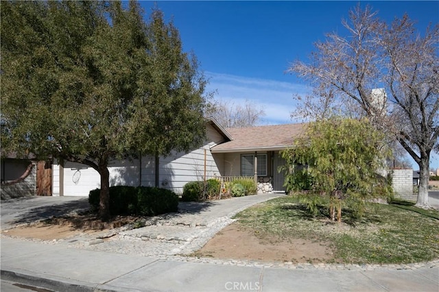 view of property hidden behind natural elements featuring a shingled roof and a garage