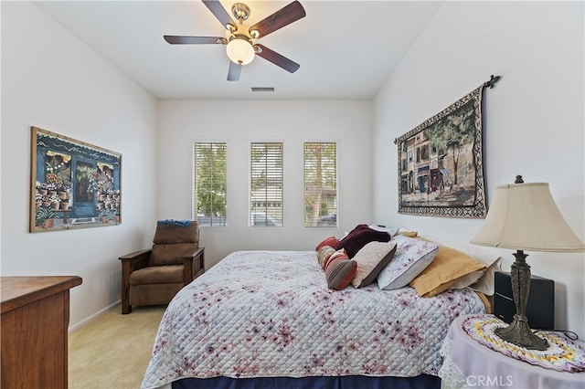 bedroom with light colored carpet, baseboards, a ceiling fan, and visible vents