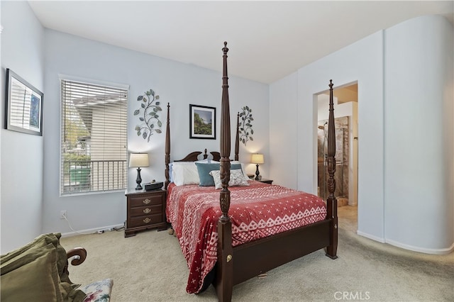 bedroom with baseboards and light colored carpet