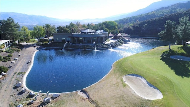 view of pool with view of golf course and a water and mountain view