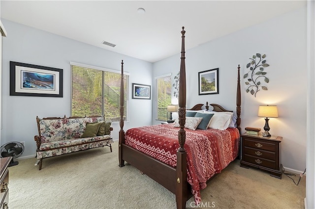 carpeted bedroom with visible vents and baseboards