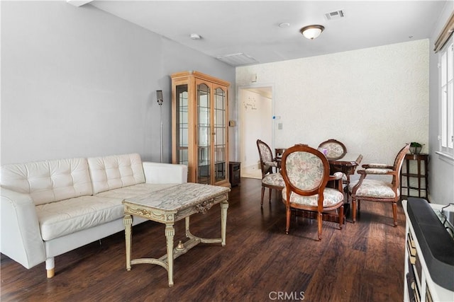 interior space with wood finished floors and visible vents
