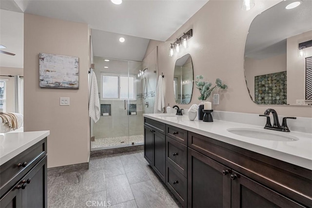 full bath with a sink, double vanity, recessed lighting, and a shower stall