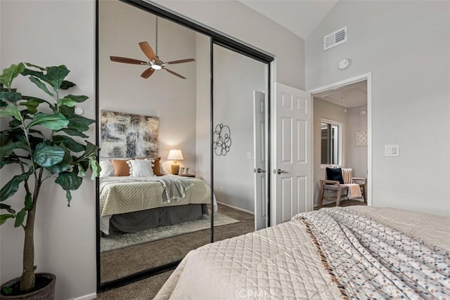 carpeted bedroom featuring visible vents, high vaulted ceiling, a closet, and ceiling fan