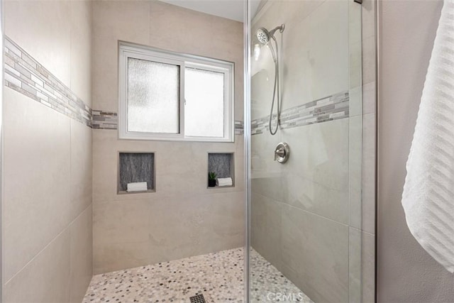 bathroom with tiled shower