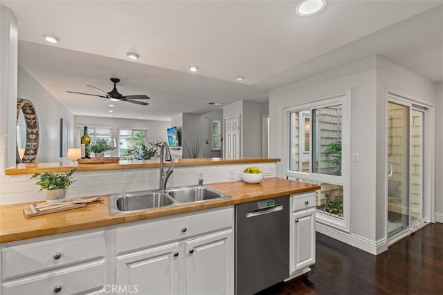 kitchen with a ceiling fan, a sink, white cabinets, dishwasher, and butcher block counters