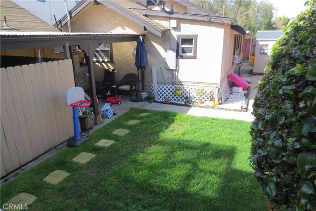 view of yard featuring a patio area and fence