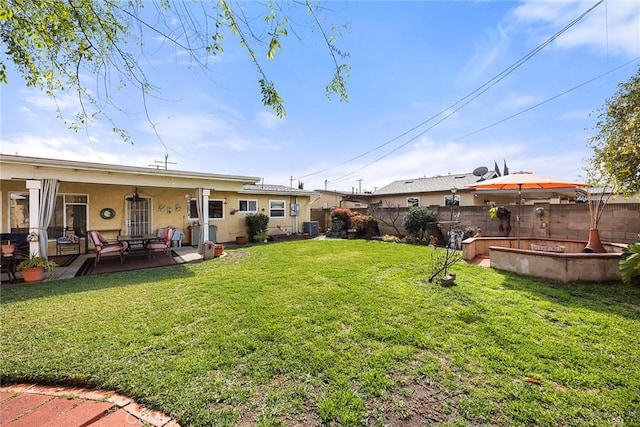 view of yard featuring a patio area, central air condition unit, and fence