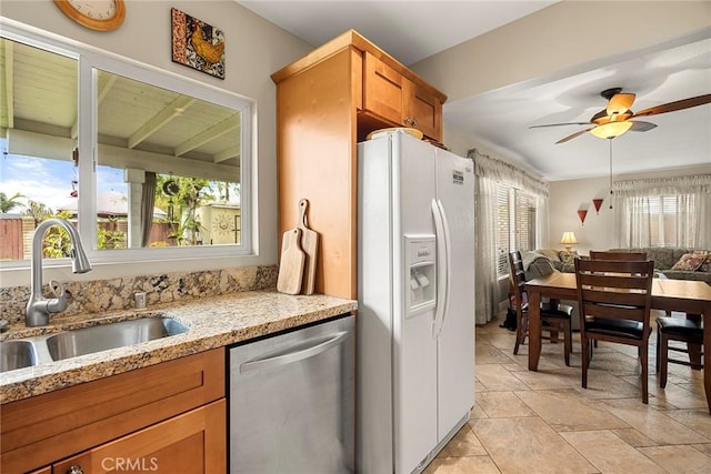 kitchen featuring a sink, stainless steel dishwasher, open floor plan, white fridge with ice dispenser, and ceiling fan