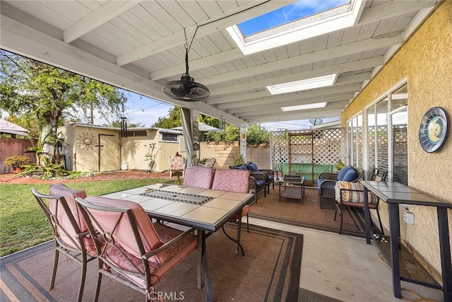 view of patio featuring an outbuilding, an outdoor living space, outdoor dining area, and a fenced backyard