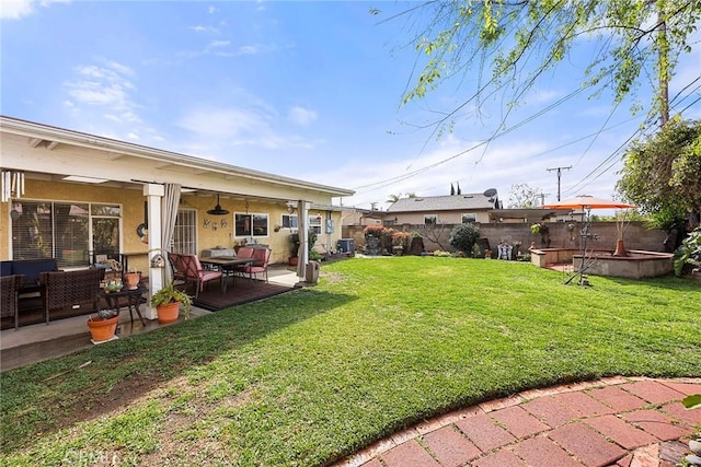 view of yard featuring a patio area, outdoor lounge area, and fence