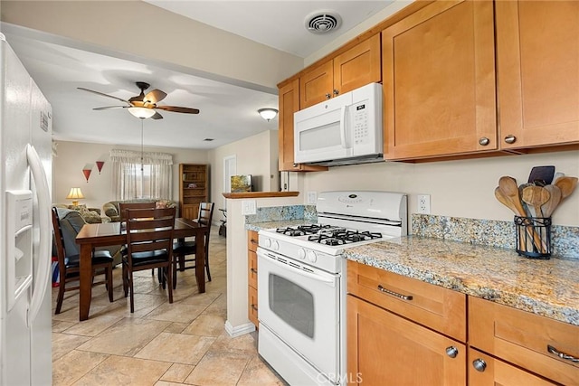 kitchen featuring white appliances, brown cabinetry, a ceiling fan, visible vents, and open floor plan