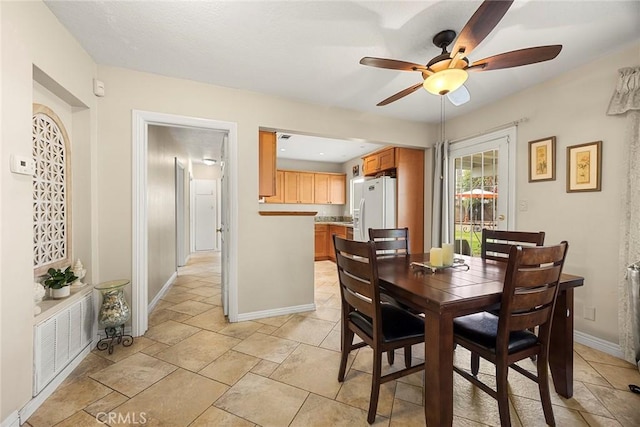 dining room with baseboards and a ceiling fan