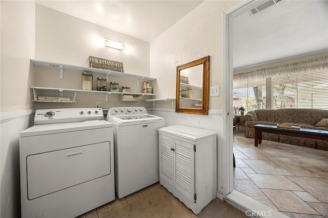 clothes washing area with laundry area, independent washer and dryer, and visible vents