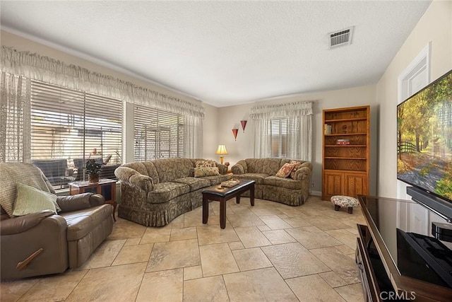 living room featuring visible vents and a textured ceiling